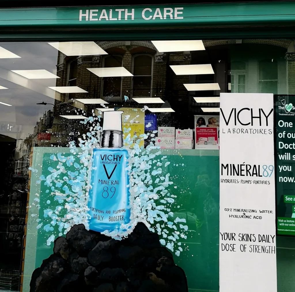 Hand painted window art for business featuring VICHY Product promotion