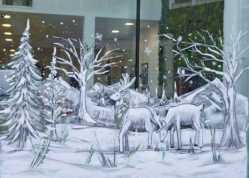 Hand painted window art - winter snow scene of two reindeer.