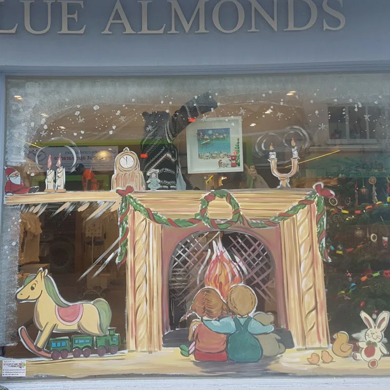 Window art for business - Christmas scene, children in front of fireplace.